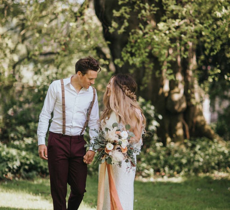 Boho Bride and Groom Holding Hands