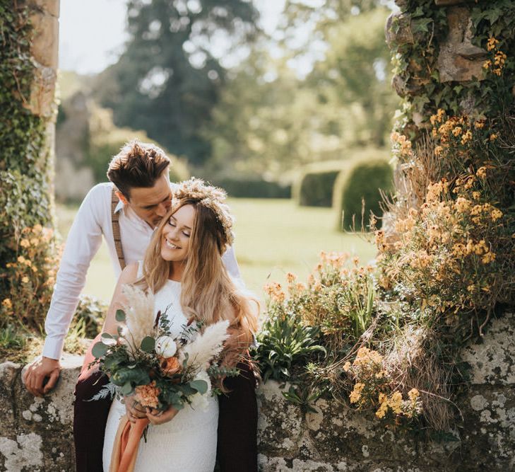 Boho Bride and Groom Kissing at Jervaulx Abbey