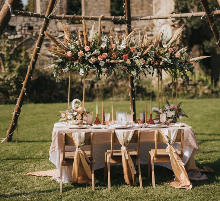 Outdoor Tablescape with Floral Installation, Linens, and Taper Candles