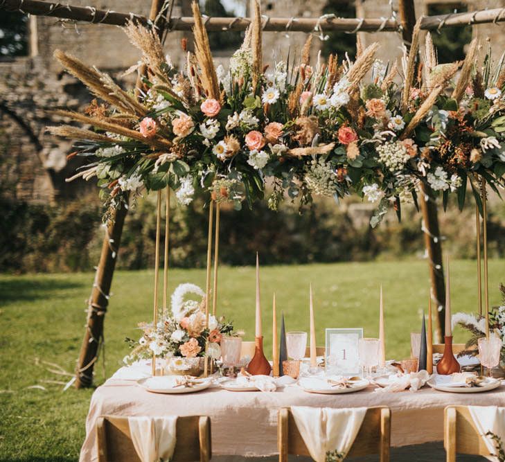 Tablescape with Linen Tablecloth, Taper Candles and Floral Installation