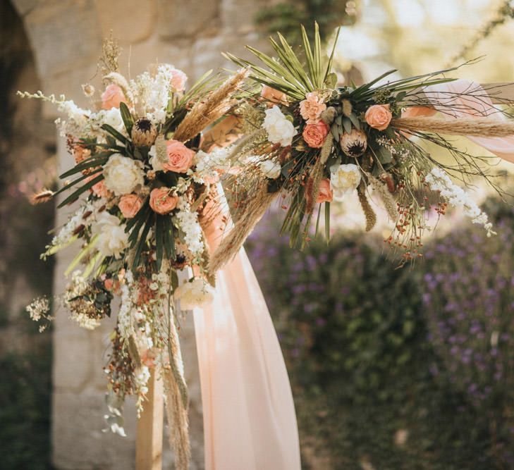 Floral Arch with Dried Grasses, Foliage, Coral Roses and Proteas