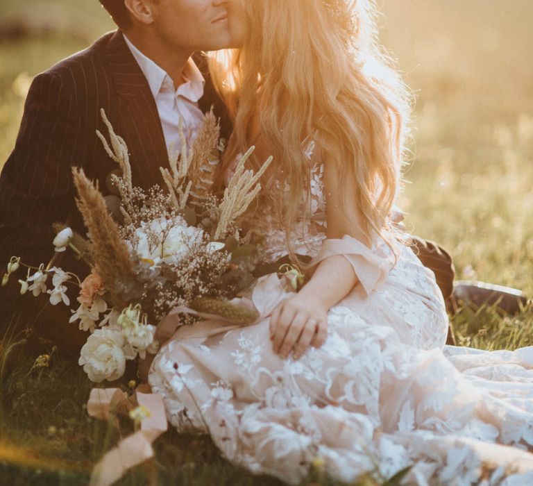 Golden Hour Portrait with Bride in Lace Wedding Dress and Dried Flower Bouquet