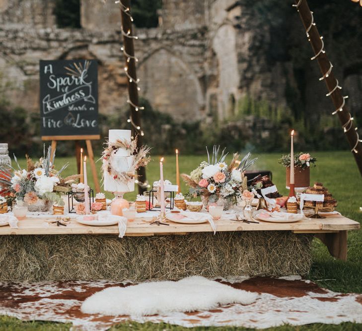 Dessert Table with Wedding Cake, Stacking Doughnuts,  Taper Candles and Wedding Flowers