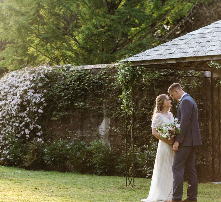 Bride in Rock The Frock Bridal Gown via The Wedding Hub | Groom in Navy Blue Wool Three Piece Suit The Vintage Suit Hire Company | Timeless English Country Garden Inspiration at Boconnoc House and Estate in Cornwall, Styled by On Serpentine Shores | Debs Alexander Photography