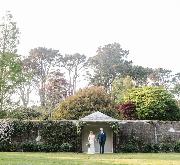 Bride in Rock The Frock Bridal Gown via The Wedding Hub | Groom in Navy Blue Wool Three Piece Suit The Vintage Suit Hire Company | Timeless English Country Garden Inspiration at Boconnoc House and Estate in Cornwall, Styled by On Serpentine Shores | Debs Alexander Photography