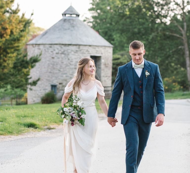 Bride in Bardot Shoulder Rock The Frock Bridal Gown via The Wedding Hub | Groom in Navy Blue Wool Three Piece Suit The Vintage Suit Hire Company | Timeless English Country Garden Inspiration at Boconnoc House and Estate in Cornwall, Styled by On Serpentine Shores | Debs Alexander Photography