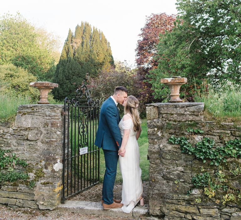 Bride in Bardot Shoulder Rock The Frock Bridal Gown via The Wedding Hub | Groom in Navy Blue Wool Three Piece Suit The Vintage Suit Hire Company | Timeless English Country Garden Inspiration at Boconnoc House and Estate in Cornwall, Styled by On Serpentine Shores | Debs Alexander Photography