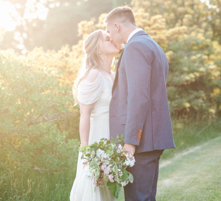 Bride in Bardot Shoulder Rock The Frock Bridal Gown via The Wedding Hub | Groom in Navy Blue Wool Three Piece Suit The Vintage Suit Hire Company | Timeless English Country Garden Inspiration at Boconnoc House and Estate in Cornwall, Styled by On Serpentine Shores | Debs Alexander Photography