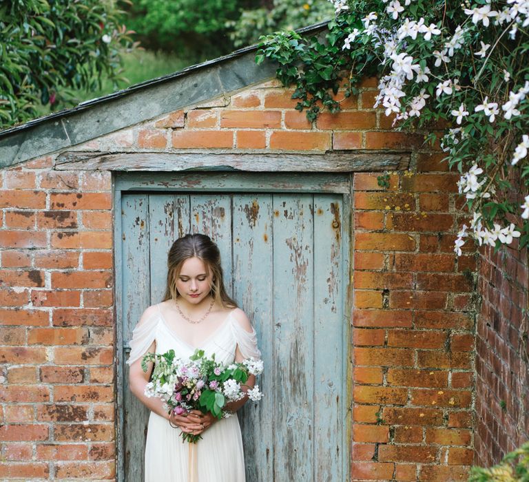 Bride in Bardot Shoulder Rock The Frock Bridal Gown via The Wedding Hub | The Garden Gate Flower Company Wedding Bouquet | Timeless English Country Garden Inspiration at Boconnoc House and Estate in Cornwall, Styled by On Serpentine Shores | Debs Alexander Photography