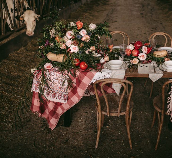 Intimate tablescape with gingham cloth, bread and apples