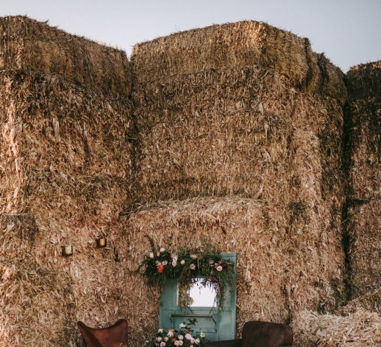 Chill out area with chairs and barn door decorated in flowers