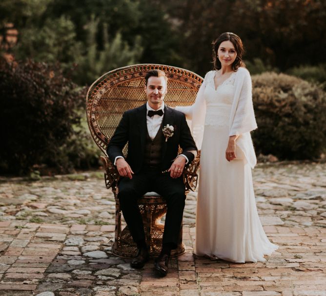 Bride and groom on rattan chair