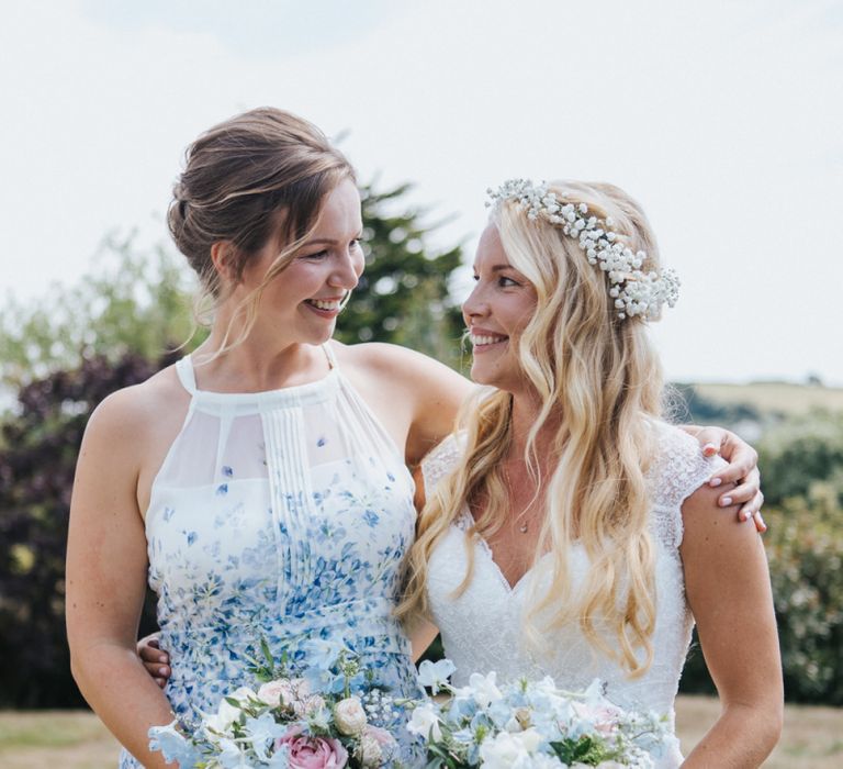 Bride in Sophia Tolli Galene Wedding Dress and Bridesmaid in Blue &amp; White Floral Dress