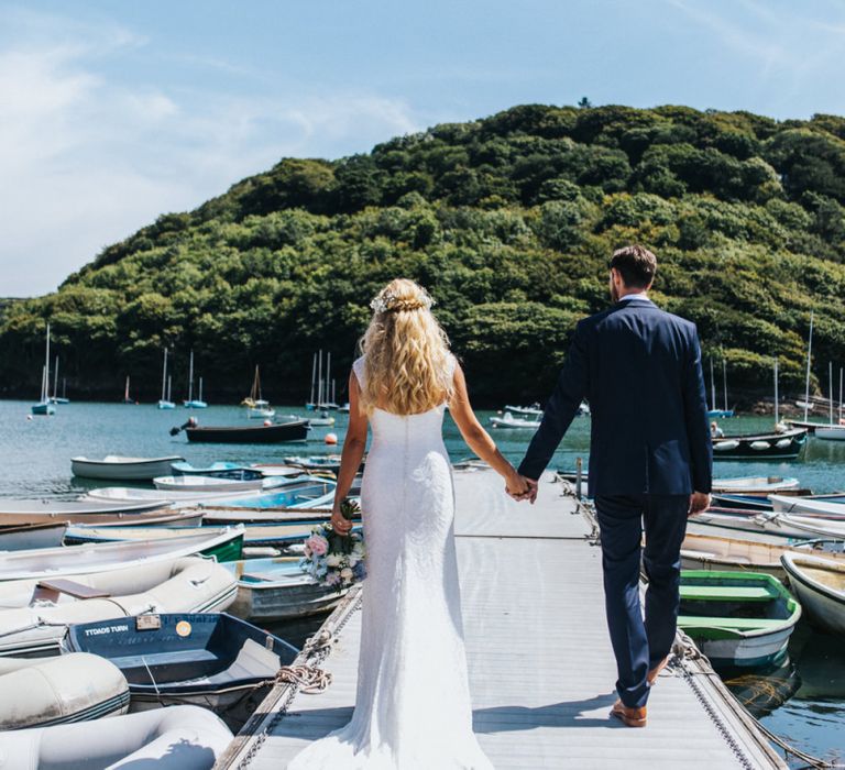 Bride in Sophia Tolli Galene Wedding Dress and Groom in Navy Blue Ted Baker Suit Walking on the Dock