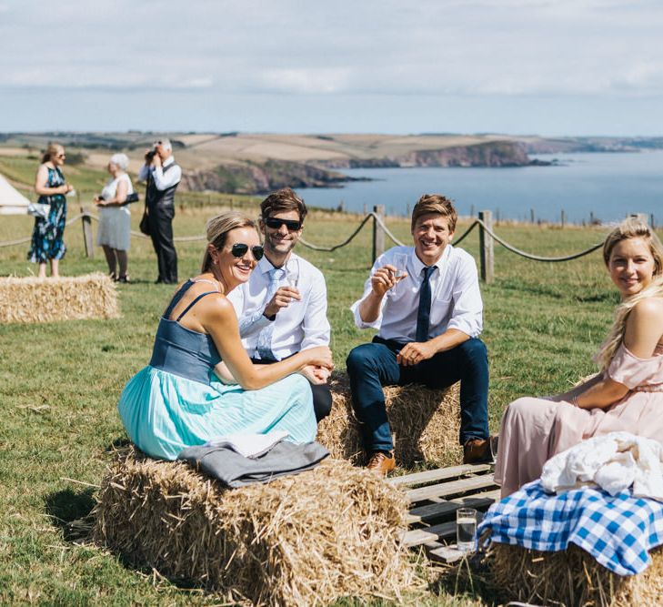 Wedding Guests Sitting on Hay Bales