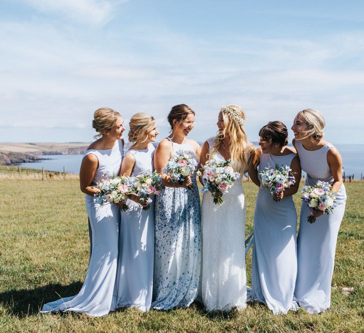 Bridal Party Portrait with Maid of Honour in Floral Dress, Bridesmaids in Pale Blue Dresses and Bride in Sophia Tolli Wedding Dress