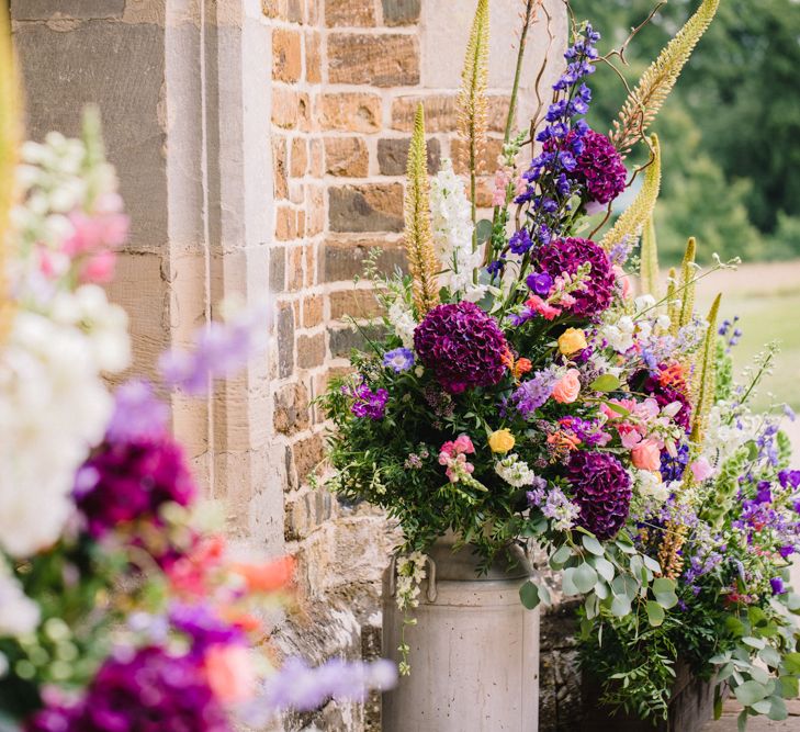 Brightly Coloured Floral Arrangements In Urns // Image By Studio TM