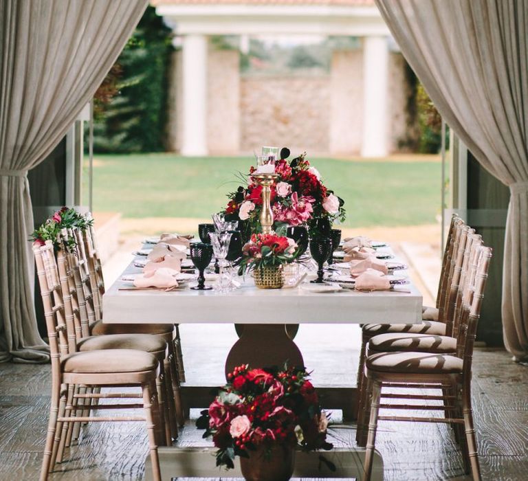 Luxury Table Scape with Red and Black Flowers and Tableware