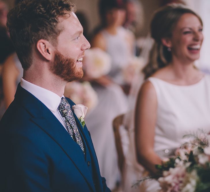 Civil Ceremony. A Quintessentially British Venue at Cambridge Cottage, Royal Botanic Gardens Kew. Bride Wears Paloma Blanca from Pure Couture Bridal and Groom Wears Tailored Suit from Hackett London.