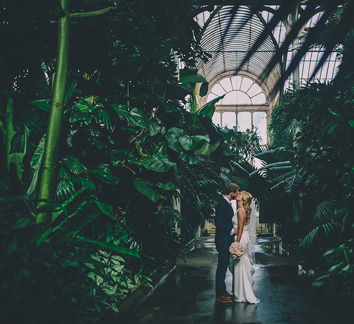 The Bride and Groom Share Some Time Together. A Quintessentially British Venue at Cambridge Cottage, Royal Botanic Gardens Kew. Bride Wears Paloma Blanca from Pure Couture Bridal and Groom Wears Tailored Suit from Hackett London.