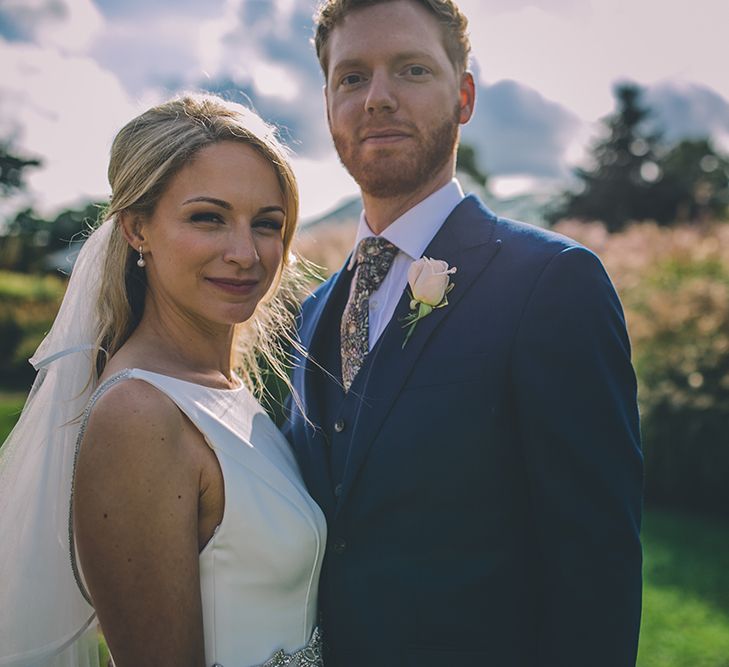 The Bride and Groom Share Some Time Together. A Quintessentially British Venue at Cambridge Cottage, Royal Botanic Gardens Kew. Bride Wears Paloma Blanca from Pure Couture Bridal and Groom Wears Tailored Suit from Hackett London.