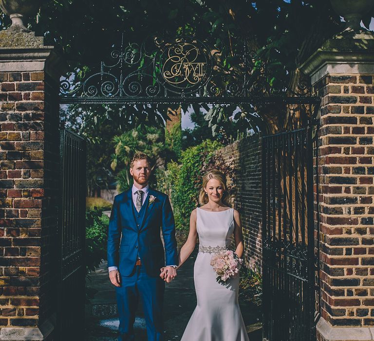 The Bride and Groom Share Some Time Together. A Quintessentially British Venue at Cambridge Cottage, Royal Botanic Gardens Kew. Bride Wears Paloma Blanca from Pure Couture Bridal and Groom Wears Tailored Suit from Hackett London.