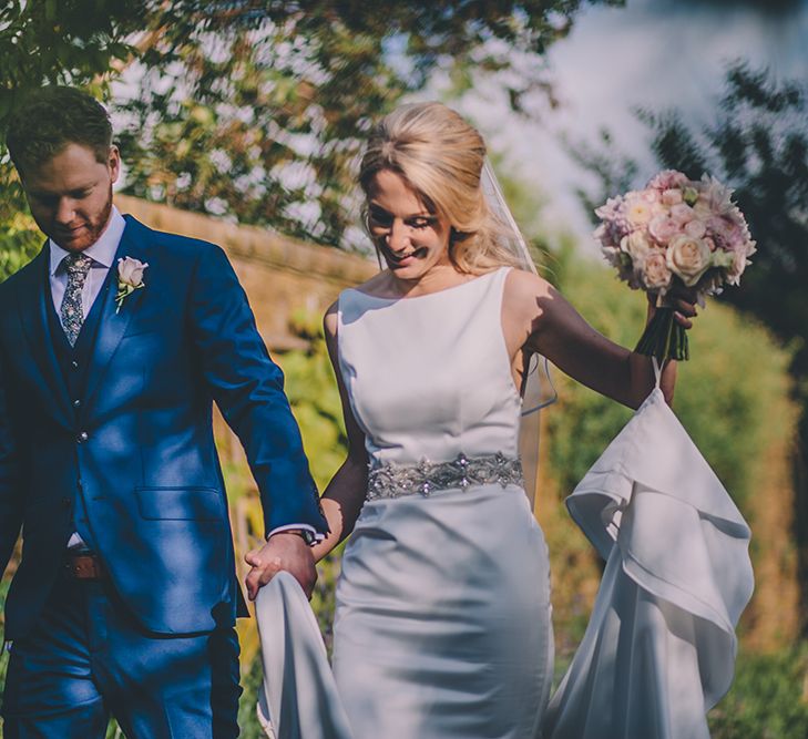 The Bride and Groom Share Some Time Together. A Quintessentially British Venue at Cambridge Cottage, Royal Botanic Gardens Kew. Bride Wears Paloma Blanca from Pure Couture Bridal and Groom Wears Tailored Suit from Hackett London.