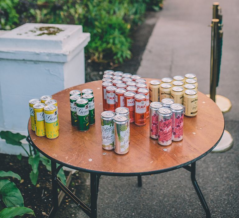 Gin in a Tin. A Quintessentially British Venue at Cambridge Cottage, Royal Botanic Gardens Kew. Bride Wears Paloma Blanca from Pure Couture Bridal and Groom Wears Tailored Suit from Hackett London.