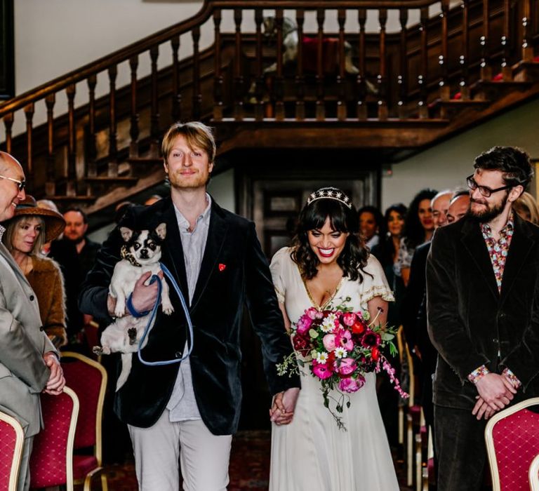 Bride and Groom Walking Down the Aisle Together with Their Pet Dog