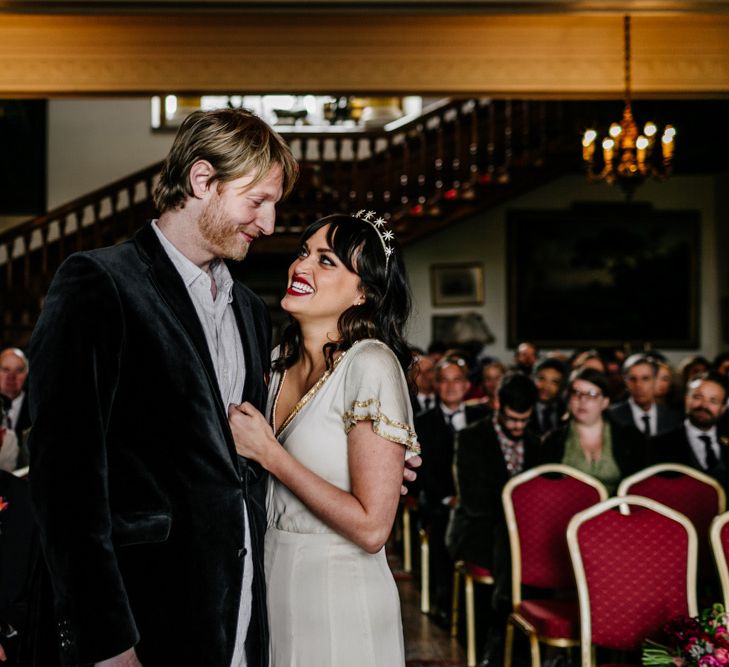 Wedding Ceremony at Walcot Hall with Happy Bride in Vintage  Wedding Dress with Gold Trims and Groom in Velvet Blazer Embracing