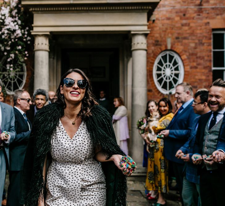 Stylish Wedding Guests with Faux Fur Coat and Shades