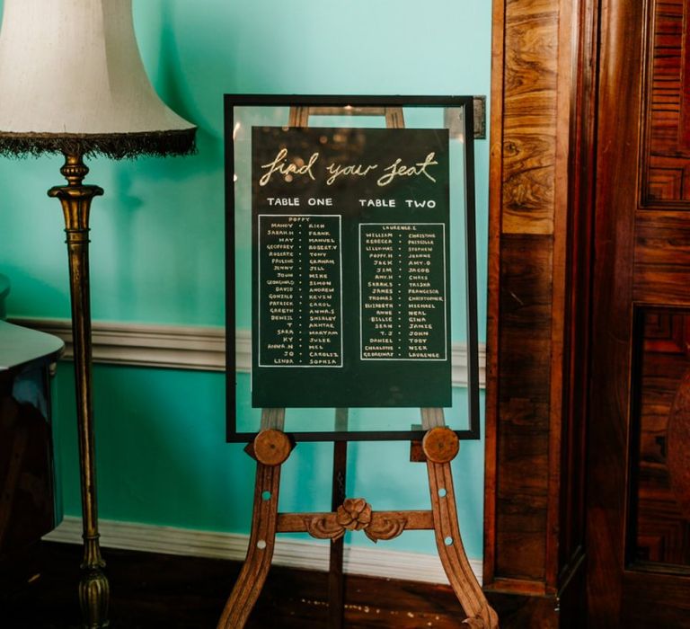 Black and Gold Wedding Seating Chart on an Easel