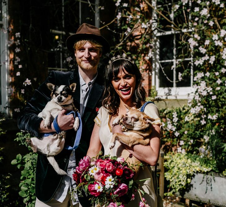 Stylish Bride and Groom Holding Their Pet Dogs