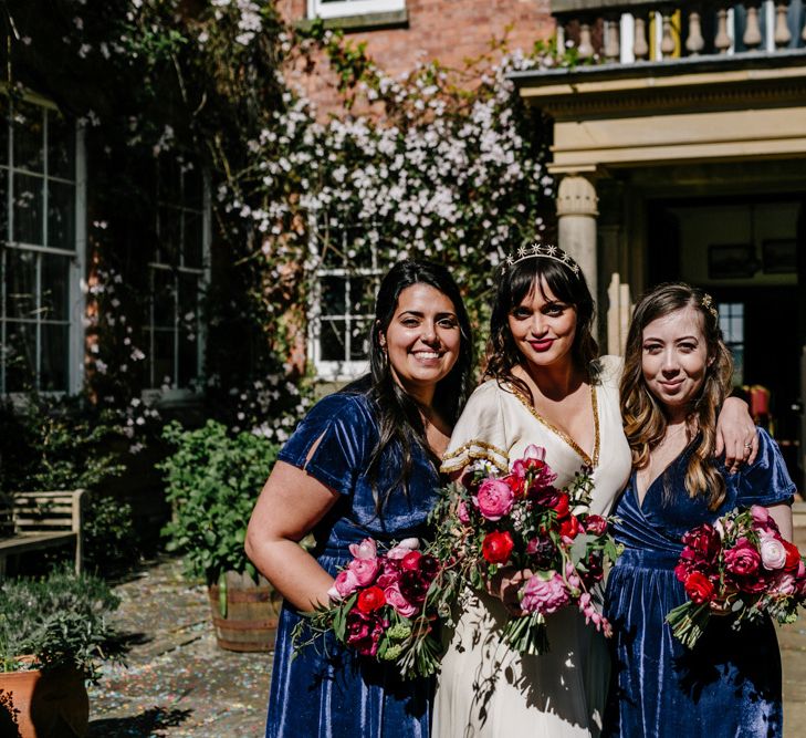 Bridal Party Portrait with Bridesmaids in Navy Blue Lindy Bop Dresses and Bride in Vintage Wedding Dress with Gold Trims