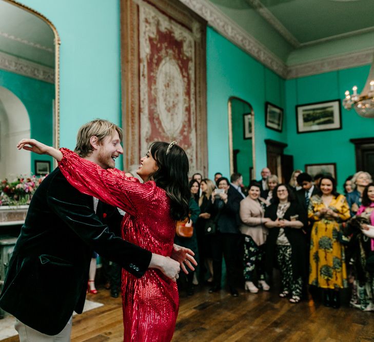 First Dance with Bride in Sequin Red Evening Dress and Groom in Navy Velvet Suit Jacket