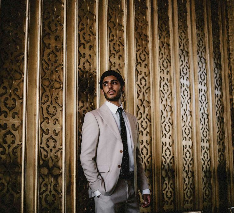 Groom in cream suit for Egypt wedding