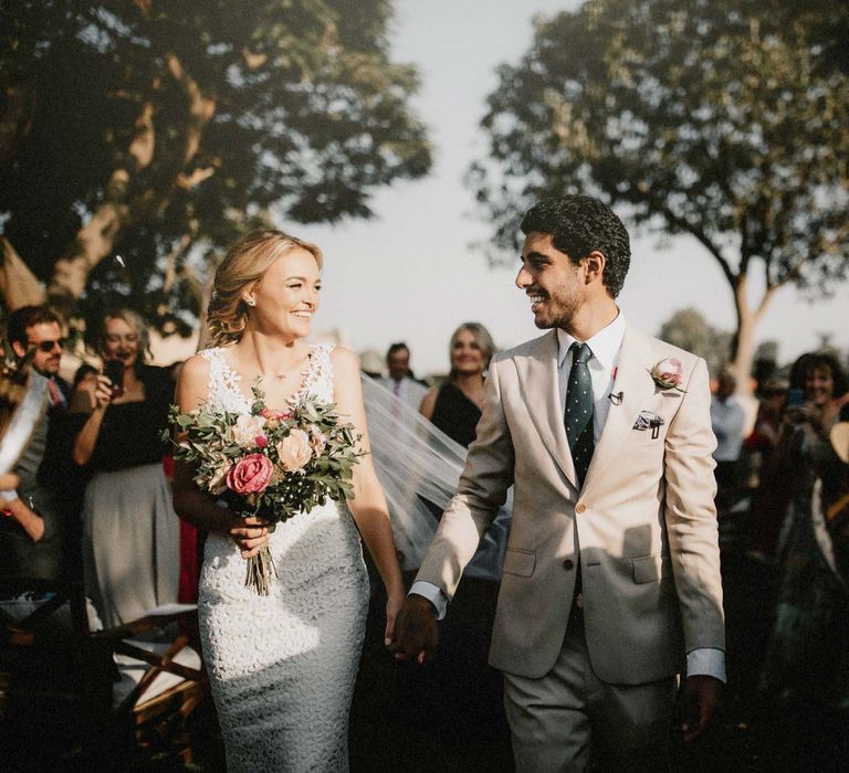 Bride and groom walk down the aisle