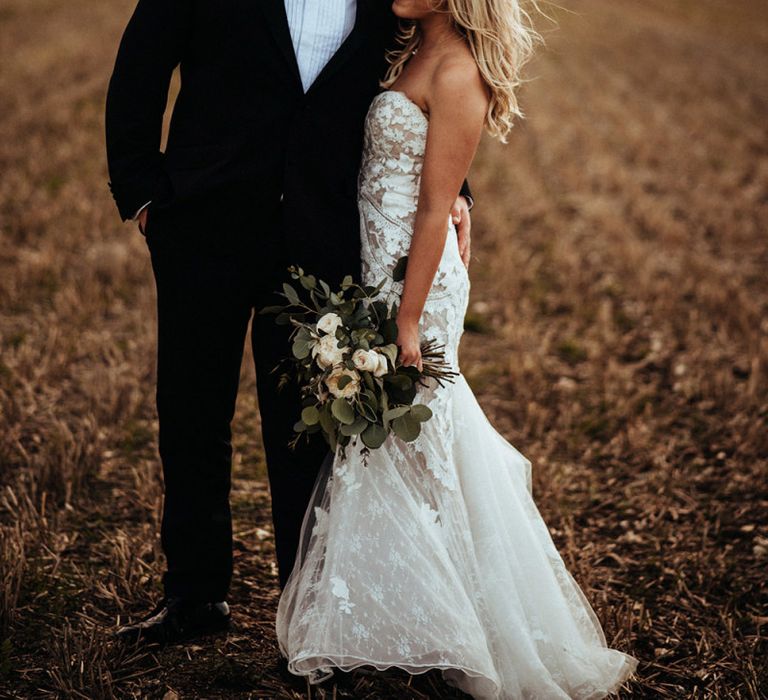 Groom in classic tuxedo for rustic wedding