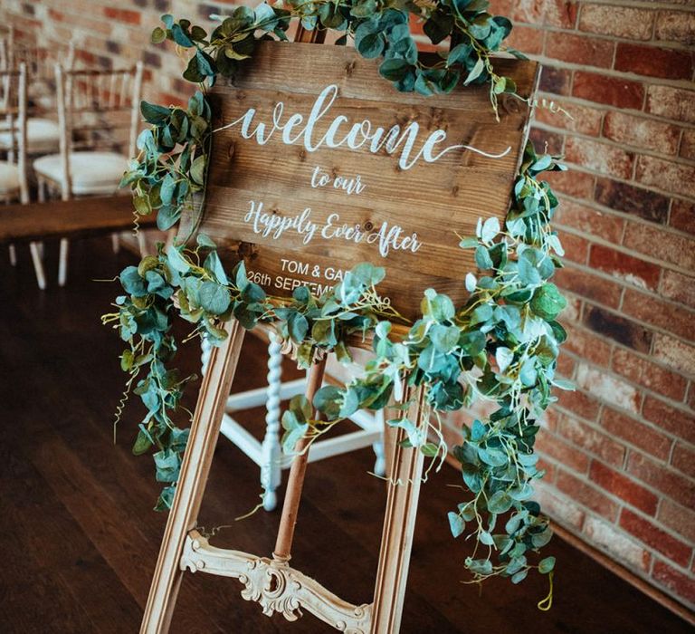 Wooden wedding sign with foliage decor