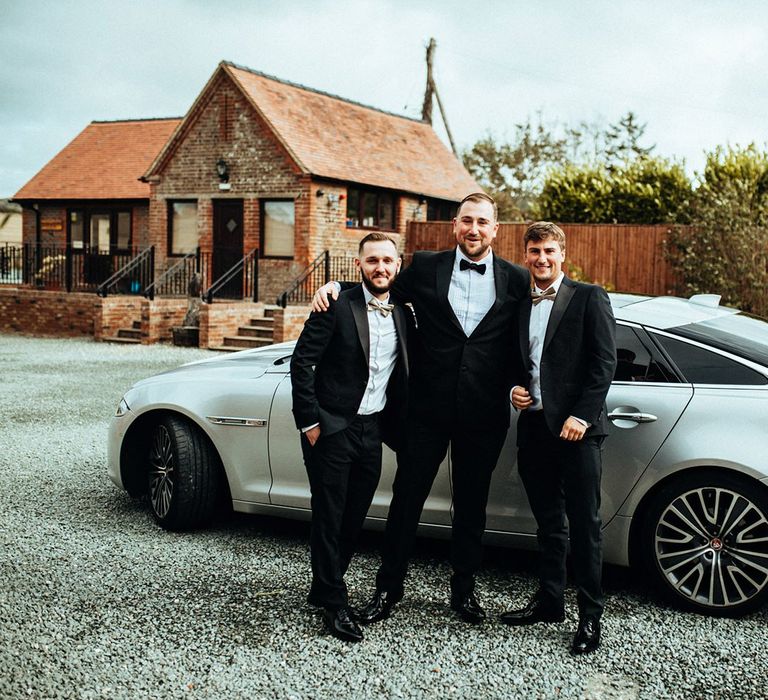 Groom and groomsmen in tuxedos at Long Furlong Barn