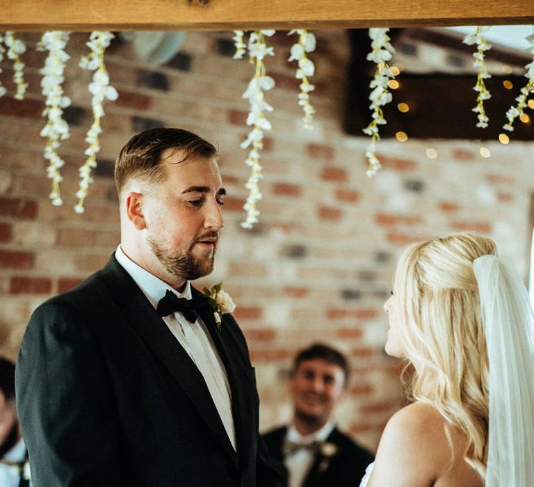 Bride and groom during barn ceremony