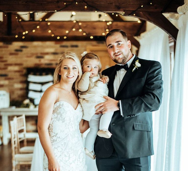 Bride and groom with daughter at wedding