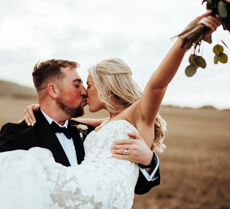 Bride and groom steal a kiss at Long Furlong Barn wedding