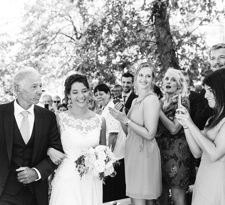 Bridal Entrance in Lace Wedding Dress | Outdoor Wedding at Commanderie de Peyrassol, Provence, France Styled by La Chuchoteuse | Lace Bridal Gown | Black Tie Suit | Rustic Stretch Tent Reception | Raisa Zwart Photography