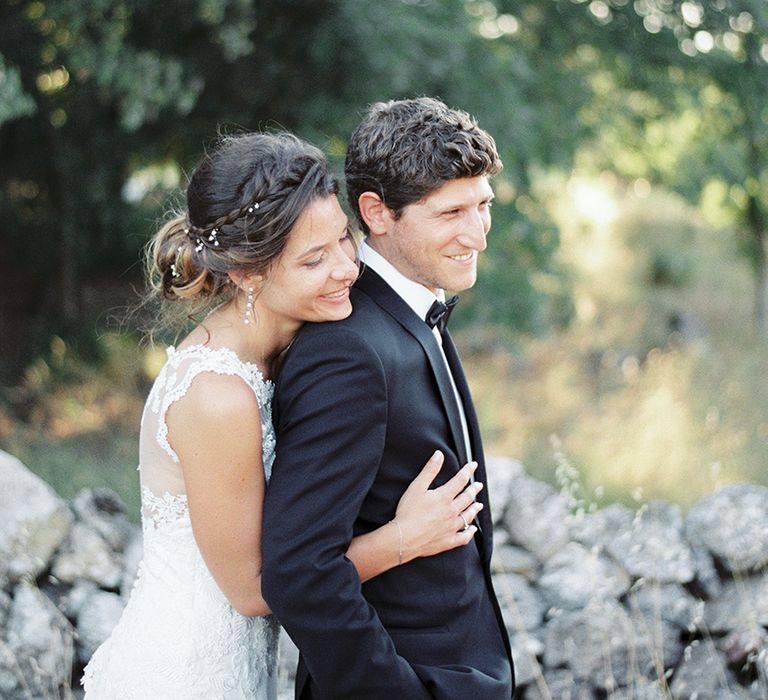 Elegant Bride in Lace Wedding Dress | Groom in Black Tie Suit | Outdoor Wedding at Commanderie de Peyrassol, Provence, France Styled by La Chuchoteuse | Lace Bridal Gown | Black Tie Suit | Rustic Stretch Tent Reception | Raisa Zwart Photography