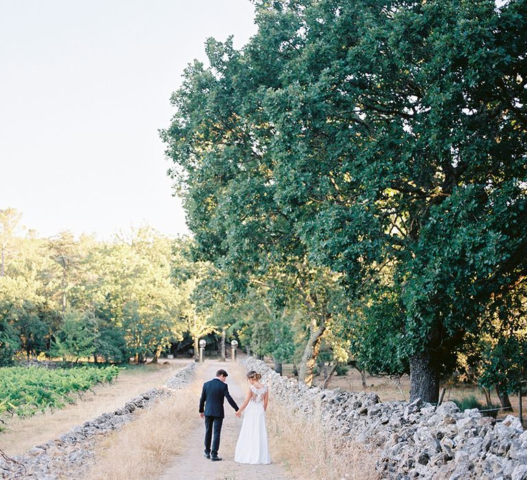 Elegant Bride in Lace Wedding Dress | Groom in Black Tie Suit | Outdoor Wedding at Commanderie de Peyrassol, Provence, France Styled by La Chuchoteuse | Lace Bridal Gown | Black Tie Suit | Rustic Stretch Tent Reception | Raisa Zwart Photography