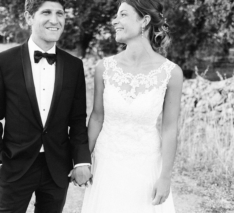 Elegant Bride in Lace Wedding Dress | Groom in Black Tie Suit | Outdoor Wedding at Commanderie de Peyrassol, Provence, France Styled by La Chuchoteuse | Lace Bridal Gown | Black Tie Suit | Rustic Stretch Tent Reception | Raisa Zwart Photography