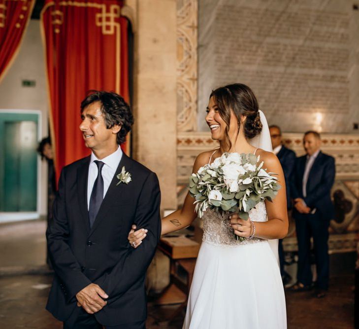 Bride walks down the aisle in Justin Alexander wedding dress