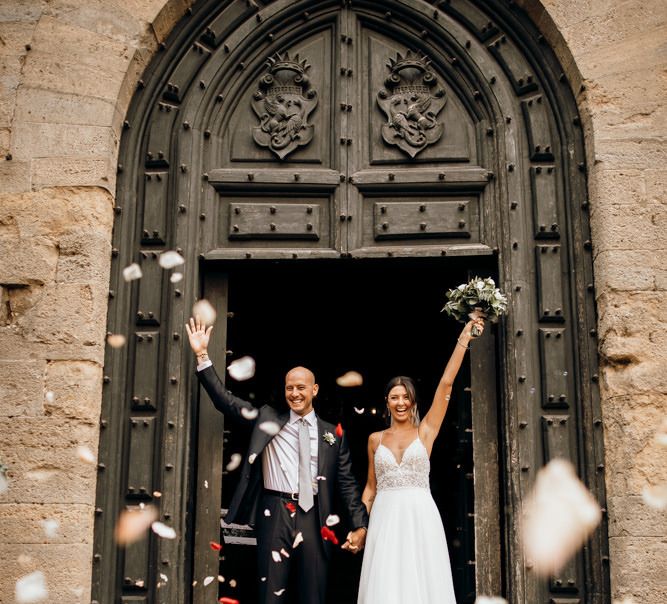 Bride and groom confetti exit at Italian wedding