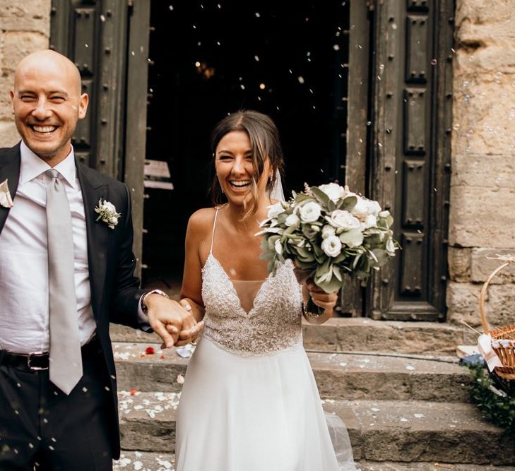 Bride and groom confetti exit at Italian wedding